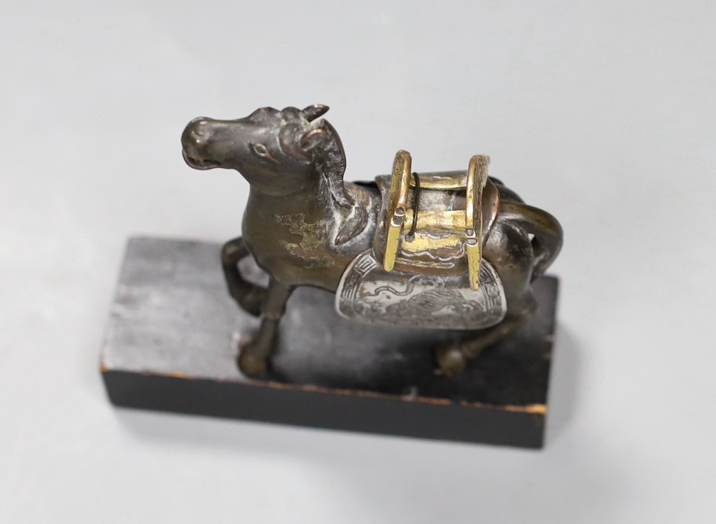 A Chinese bronze mixed metal figure a saddled horse, late 19th/early 20th century, wood stand, 8.5cms high